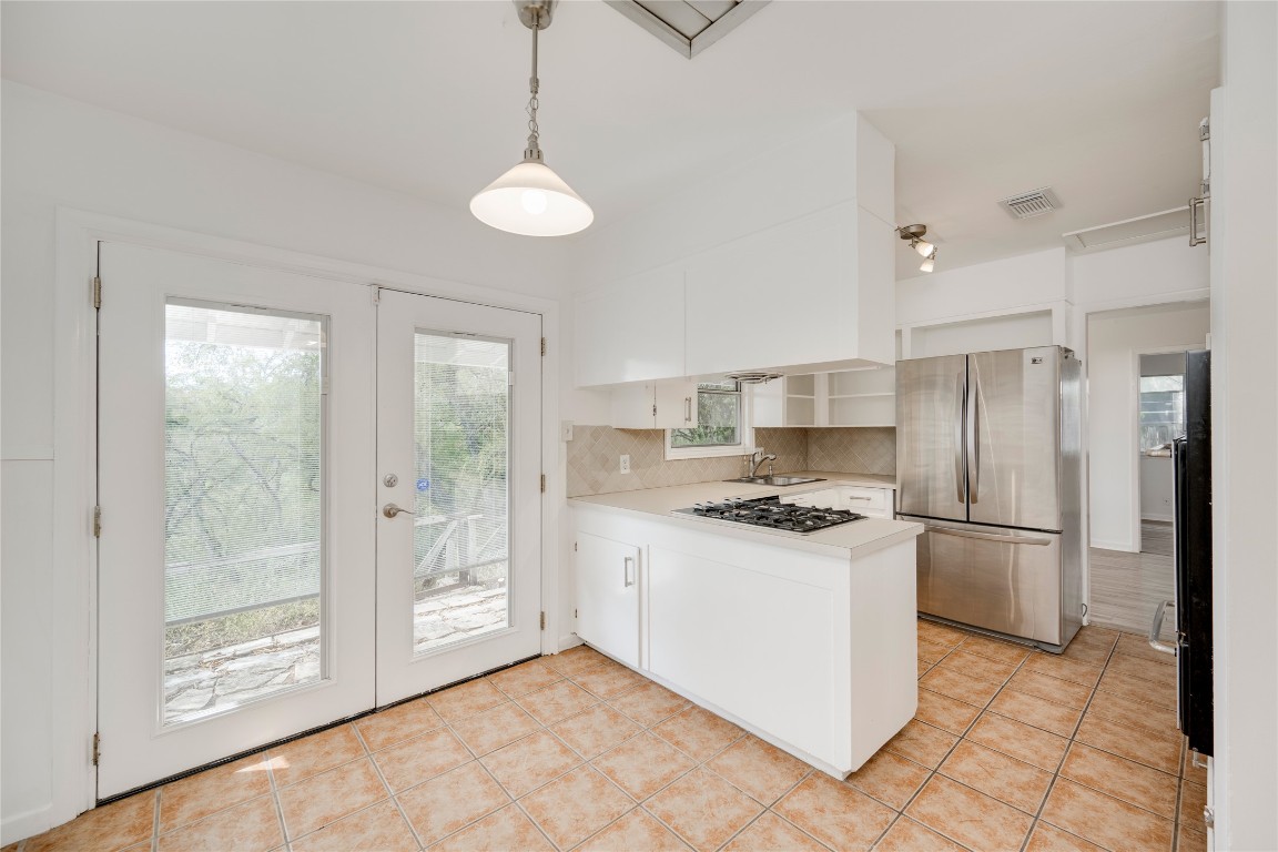 4710 Roundup Trail Austin, TX 78745 - Photo 7 of 26 a kitchen with stainless steel appliances granite countertop a refrigerator and a sink