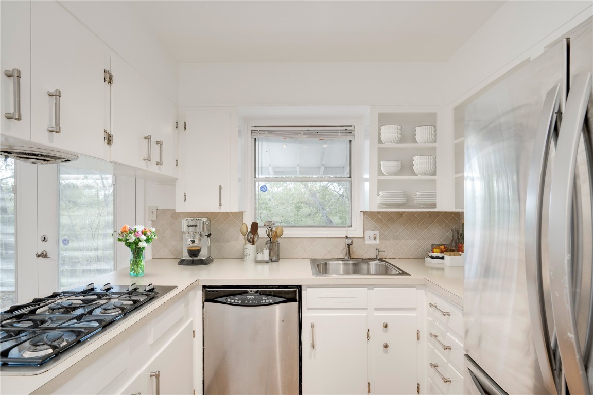 4710 Roundup Trail Austin, TX 78745 - Photo 10 of 26 a kitchen with stainless steel appliances a stove a sink a refrigerator and cabinets