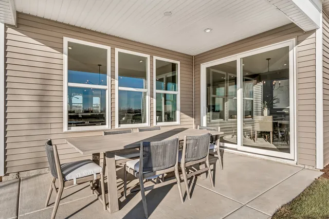 a table and chairs in front of a house