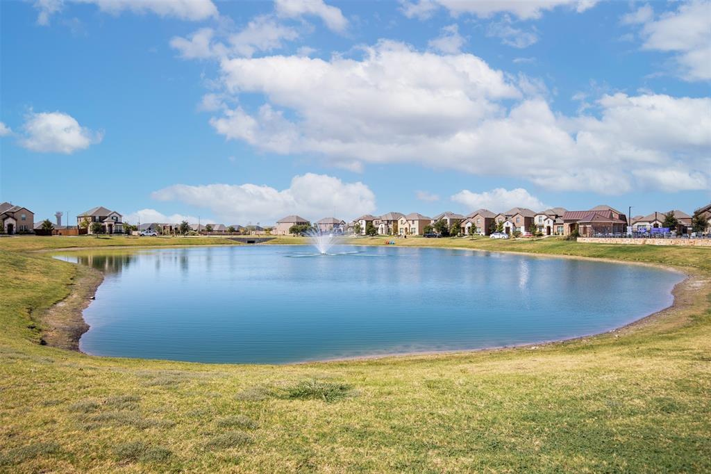 2720 Hale Road Celina, TX 75009 - Photo 35 of 40 Expansive lake with a central fountain, surrounded by manicured grassy areas and residential properties