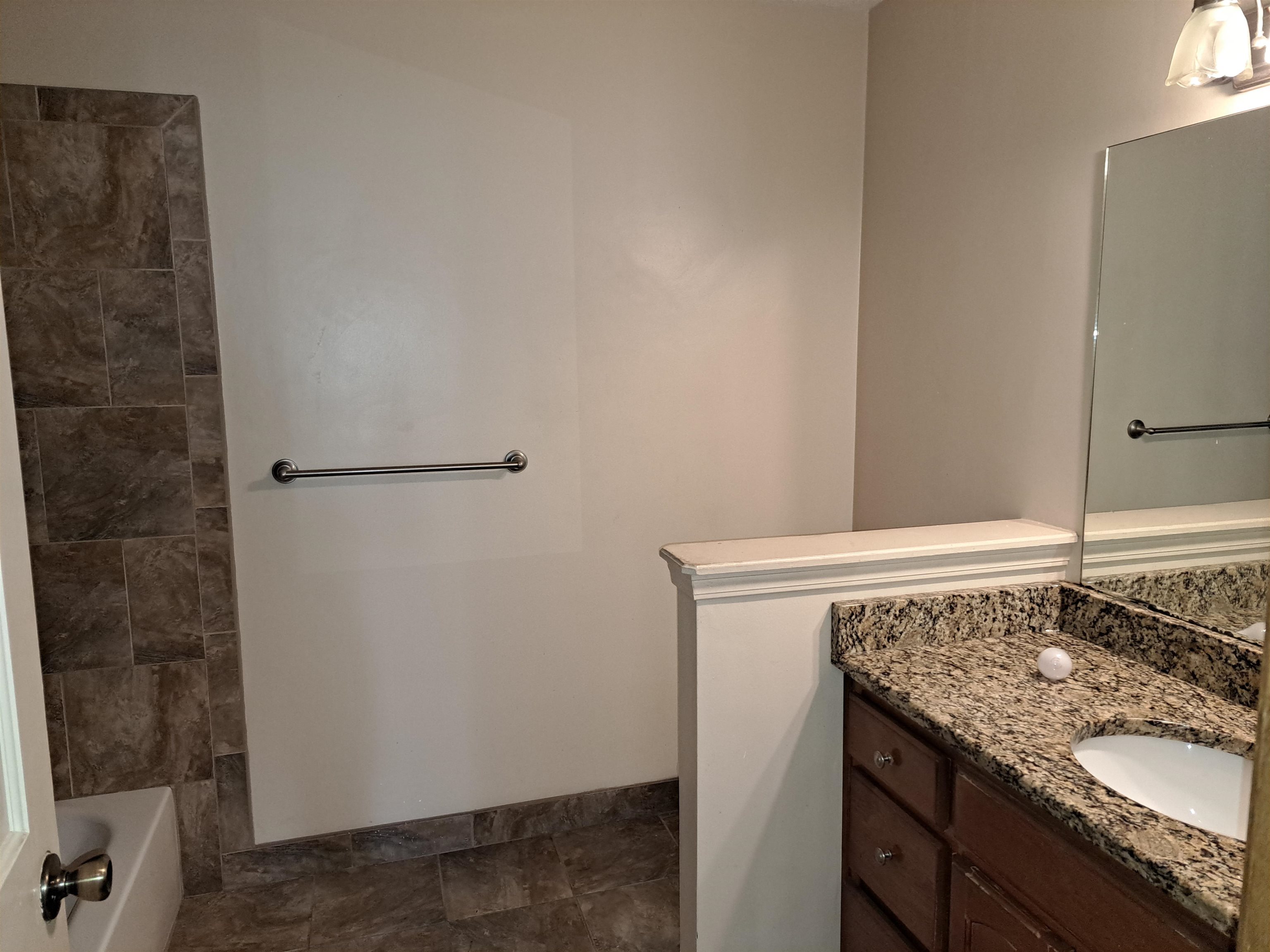3154 Raleigh Ridge Drive Memphis, TN 38128 - Photo 11 of 18 a bathroom with a granite countertop sink and white cabinets
