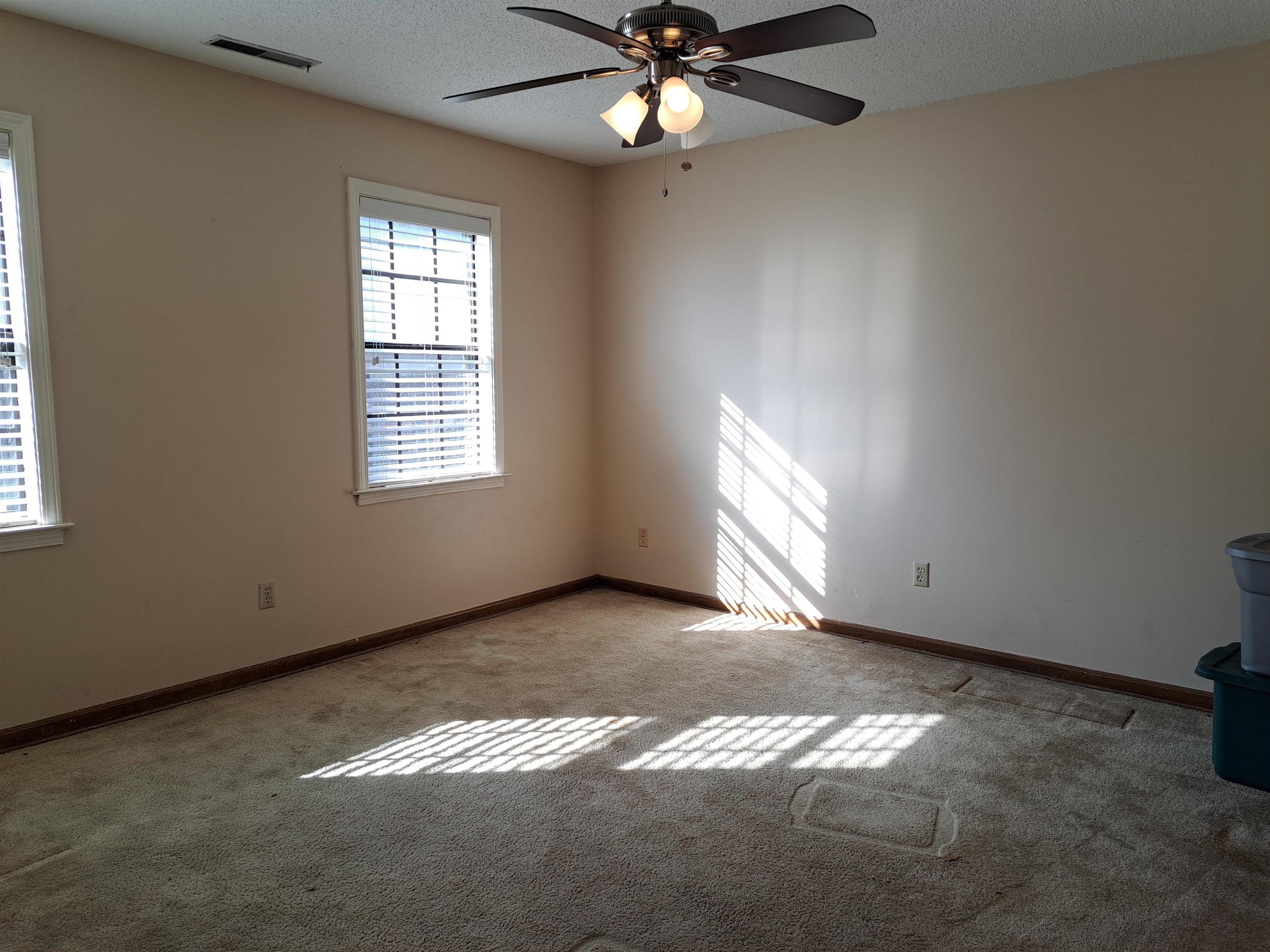 3154 Raleigh Ridge Drive Memphis, TN 38128 - Photo 12 of 18 an empty room with windows and fan