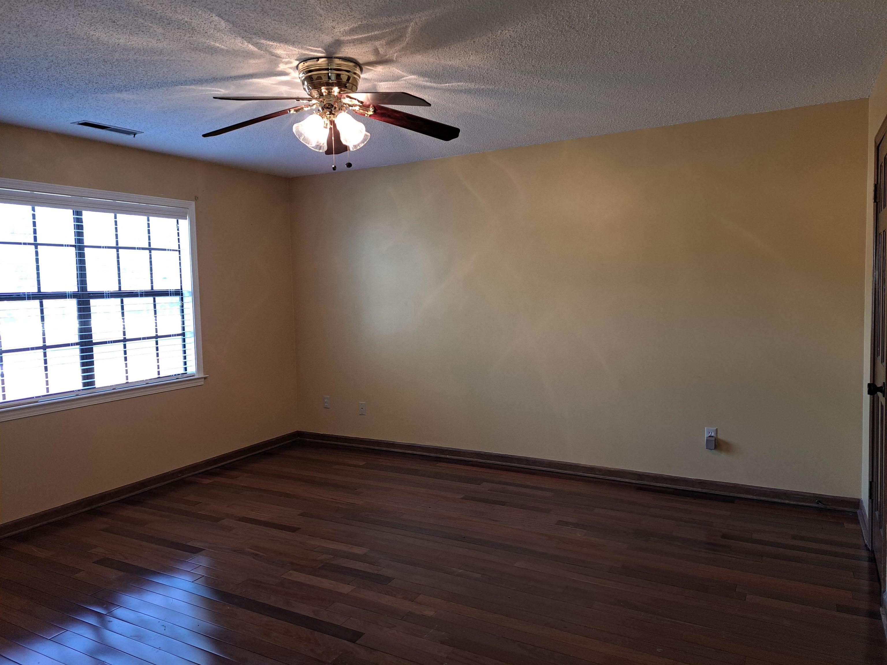 3154 Raleigh Ridge Drive Memphis, TN 38128 - Photo 7 of 18 a view of an empty room with window and wooden floor