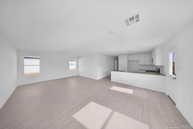a view of a kitchen with wooden cabinet and a sink