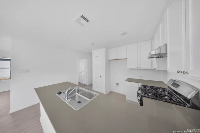 a utility room with sink dryer and washer