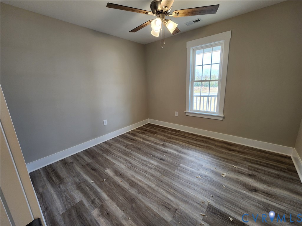Lot 2 Owens Mill Road St. Stephens Church, VA 23148 - Photo 13 of 20 an empty room with wooden floor windows and fan