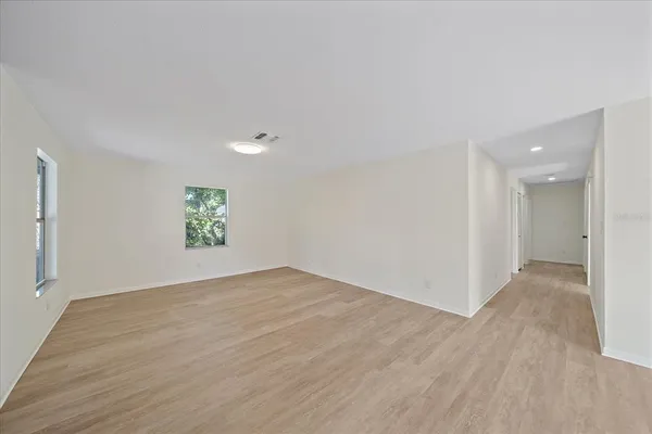 a view of an empty room and a painting on the wall