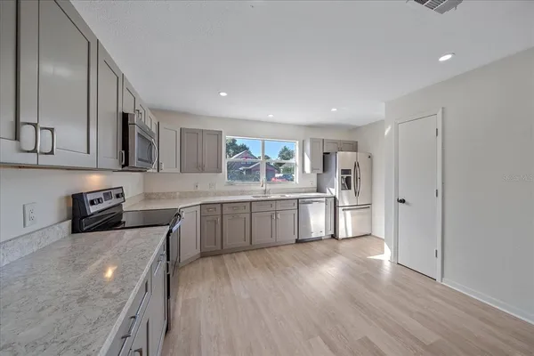 a kitchen with stainless steel appliances granite countertop a stove and a refrigerator