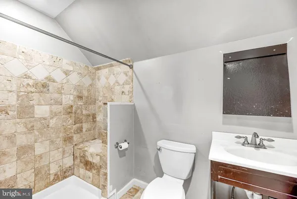 a bathroom with a toilet sink and shower