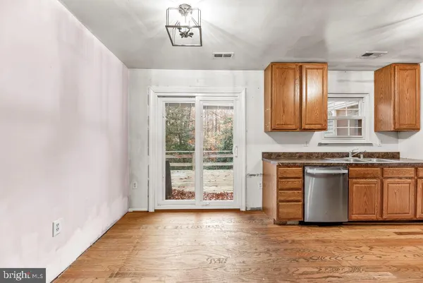 a view of a kitchen with granite countertop cabinets and a wooden floor