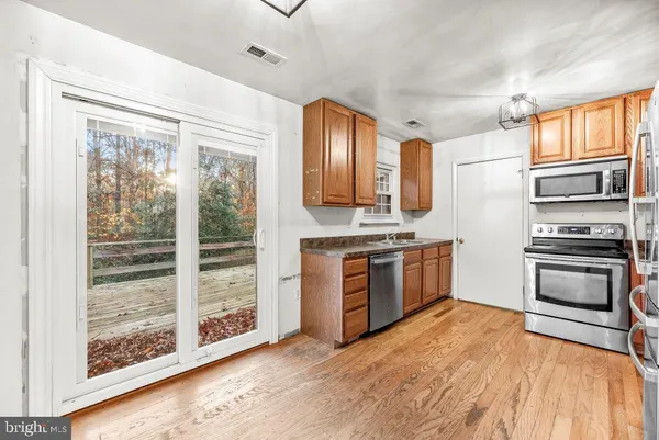 a kitchen with stainless steel appliances a stove sink and refrigerator