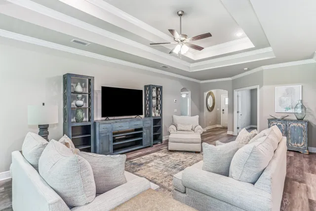 a living room with furniture and kitchen view