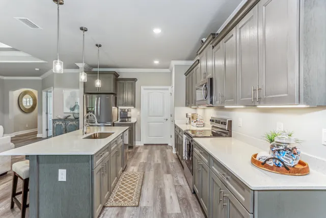 a kitchen with stainless steel appliances granite countertop a stove top oven a sink and dishwasher