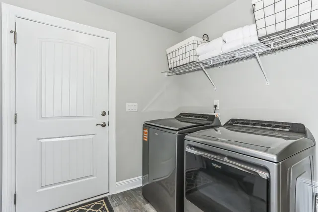 a utility room with stainless steel appliances and racks