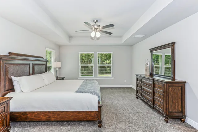 a bedroom with a bed and ceiling fan