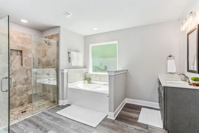 a bathroom with a bathtub and a window