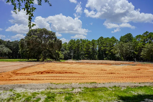 a view of a livingroom with wooden floor and a window