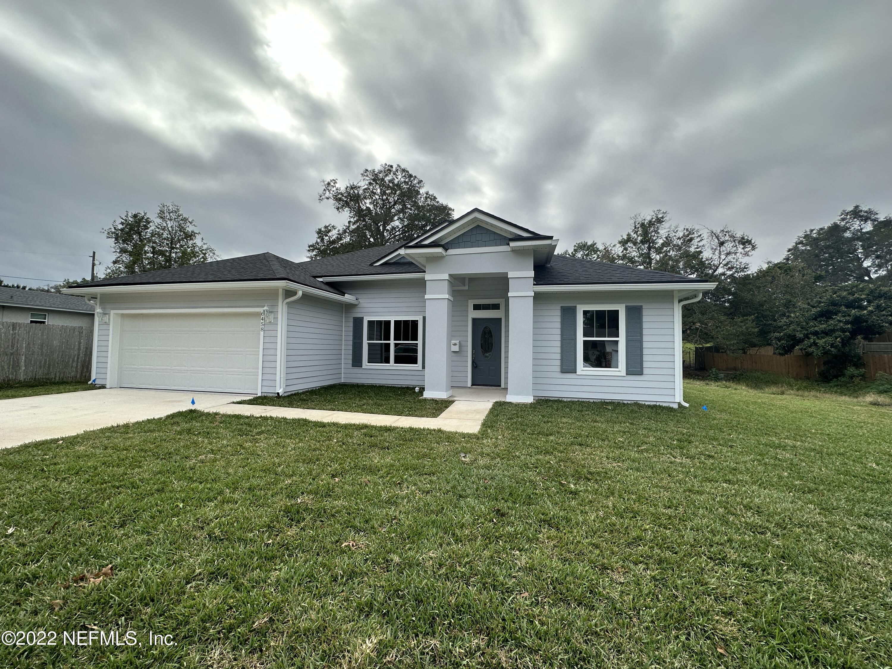 6458 Heidi Road Jacksonville, FL 32277 - Photo 1 of 26 front view of a house with a yard