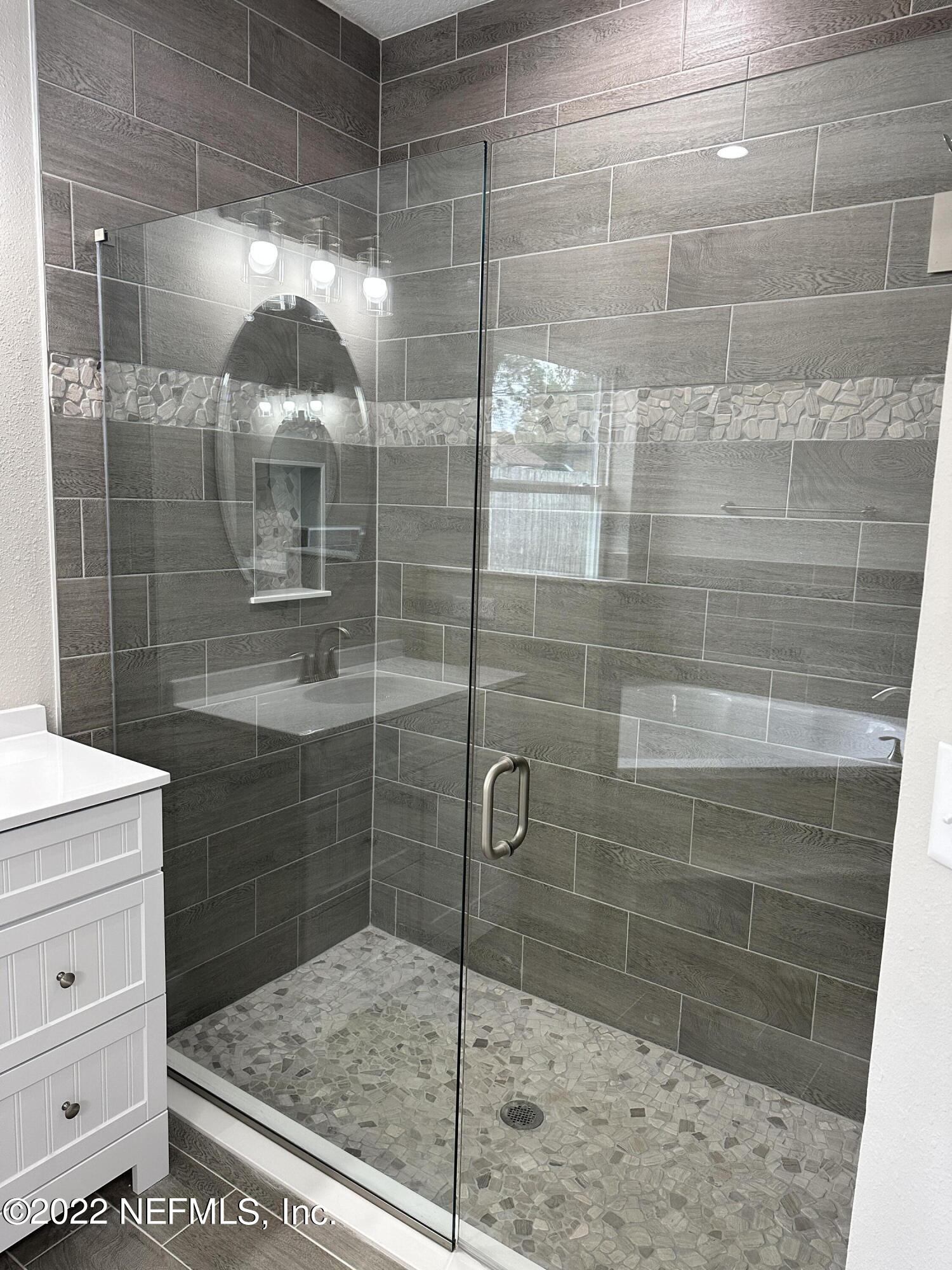 6458 Heidi Road Jacksonville, FL 32277 - Photo 16 of 26 a bathroom with a shower