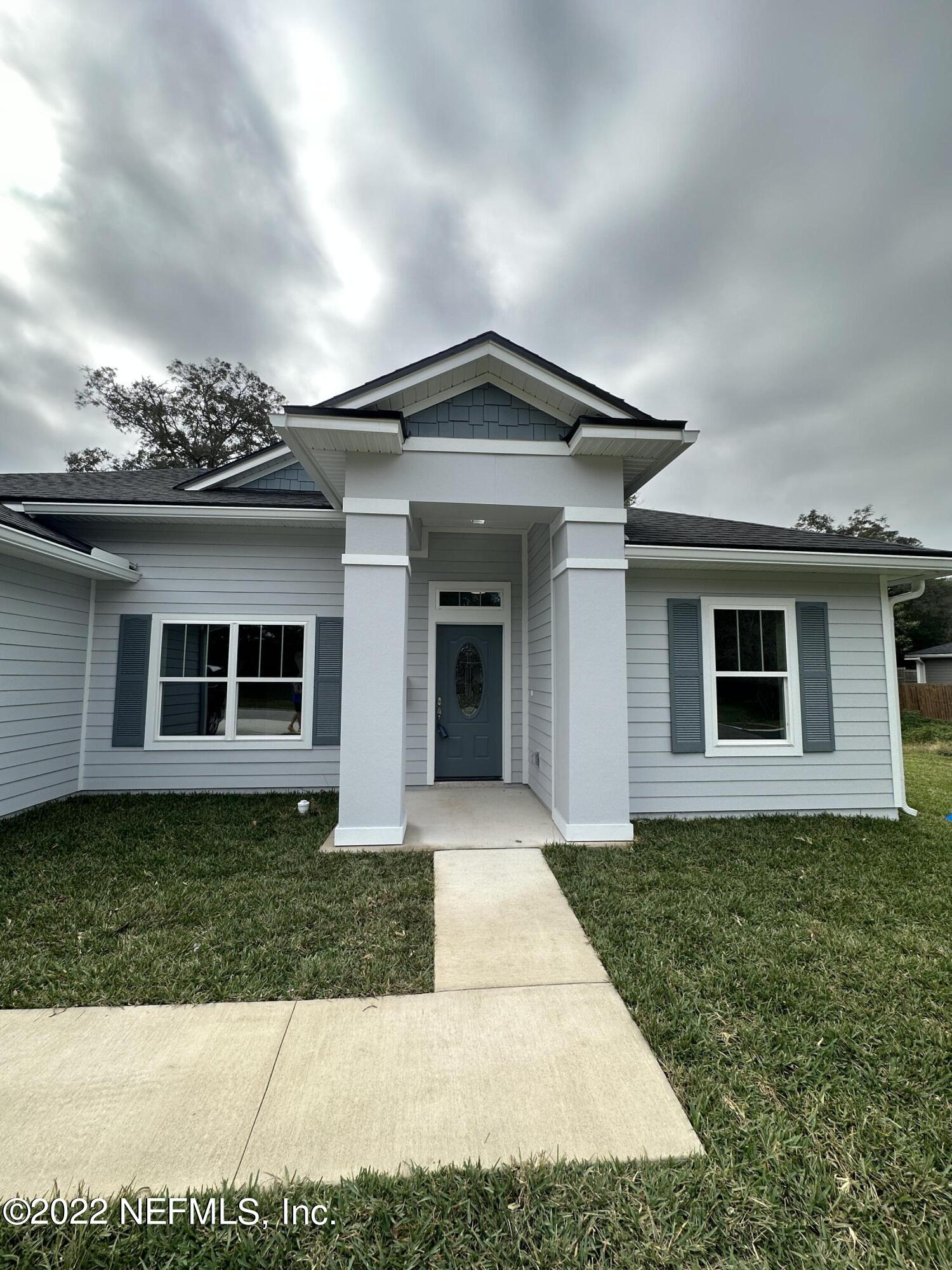 6458 Heidi Road Jacksonville, FL 32277 - Photo 2 of 26 a front view of a house with a yard