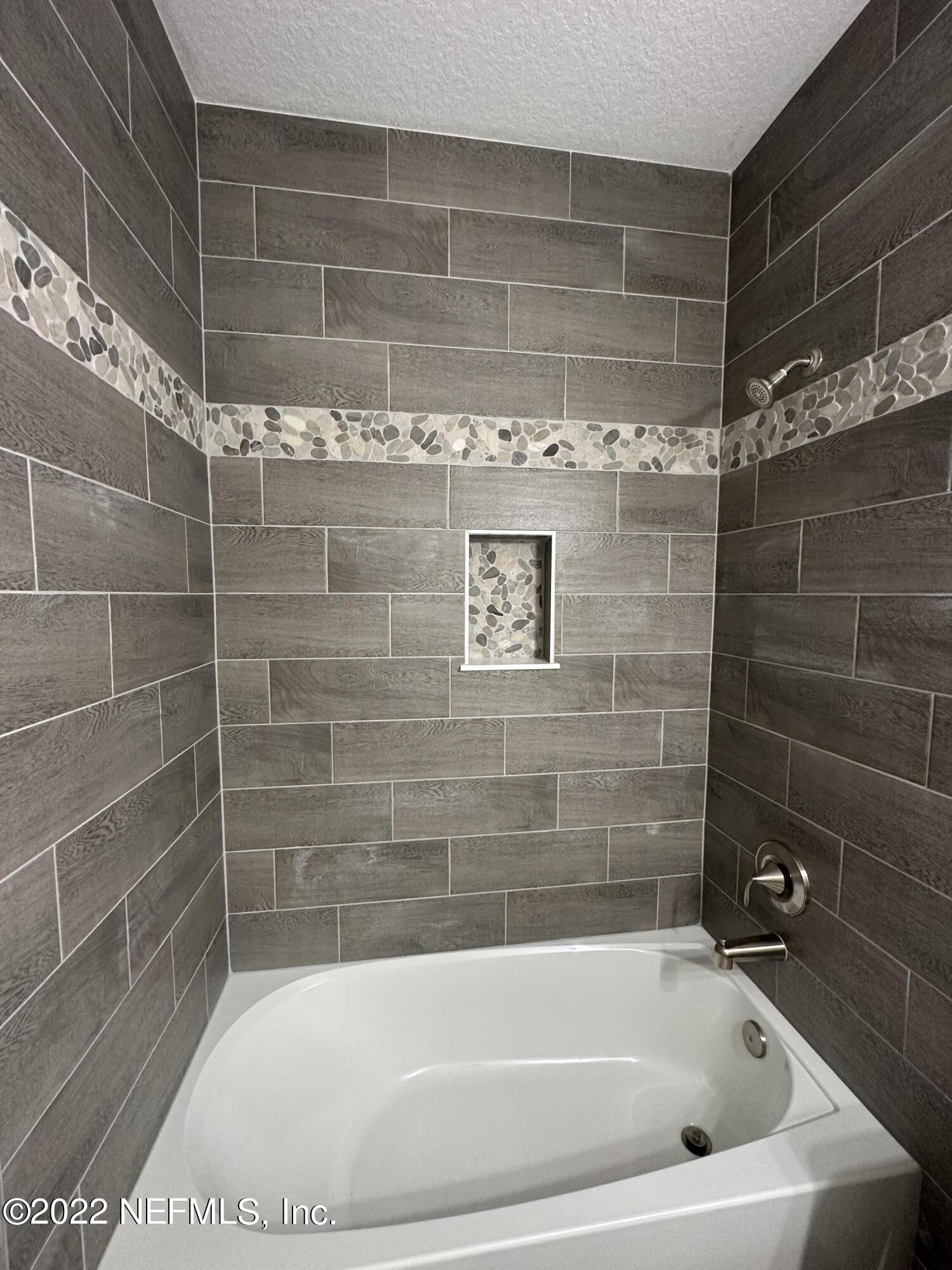 6458 Heidi Road Jacksonville, FL 32277 - Photo 23 of 26 a bathroom with a bathtub