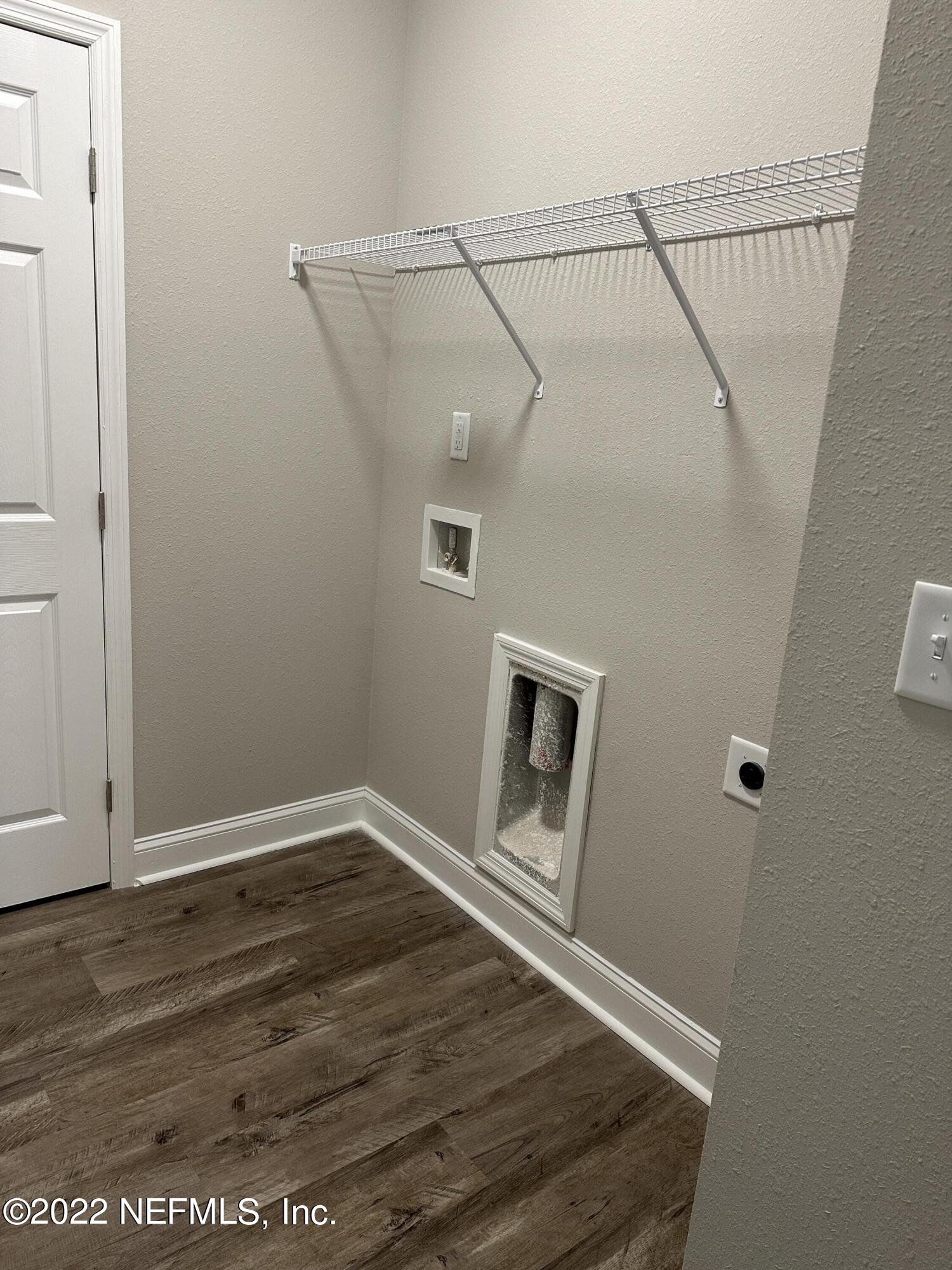 6458 Heidi Road Jacksonville, FL 32277 - Photo 24 of 26 a view of a hallway with wooden floor