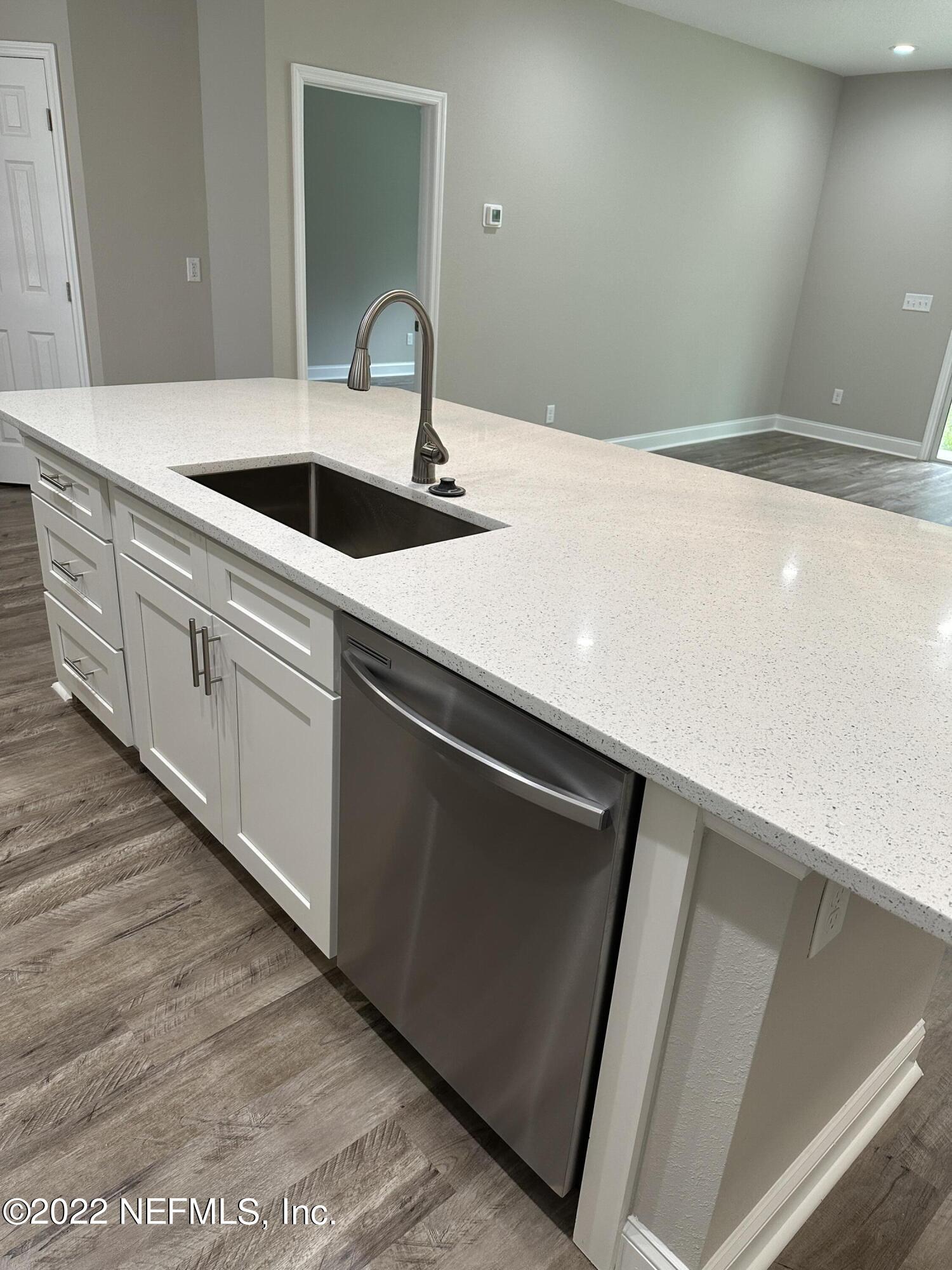 6458 Heidi Road Jacksonville, FL 32277 - Photo 5 of 26 a kitchen with a sink and a refrigerator