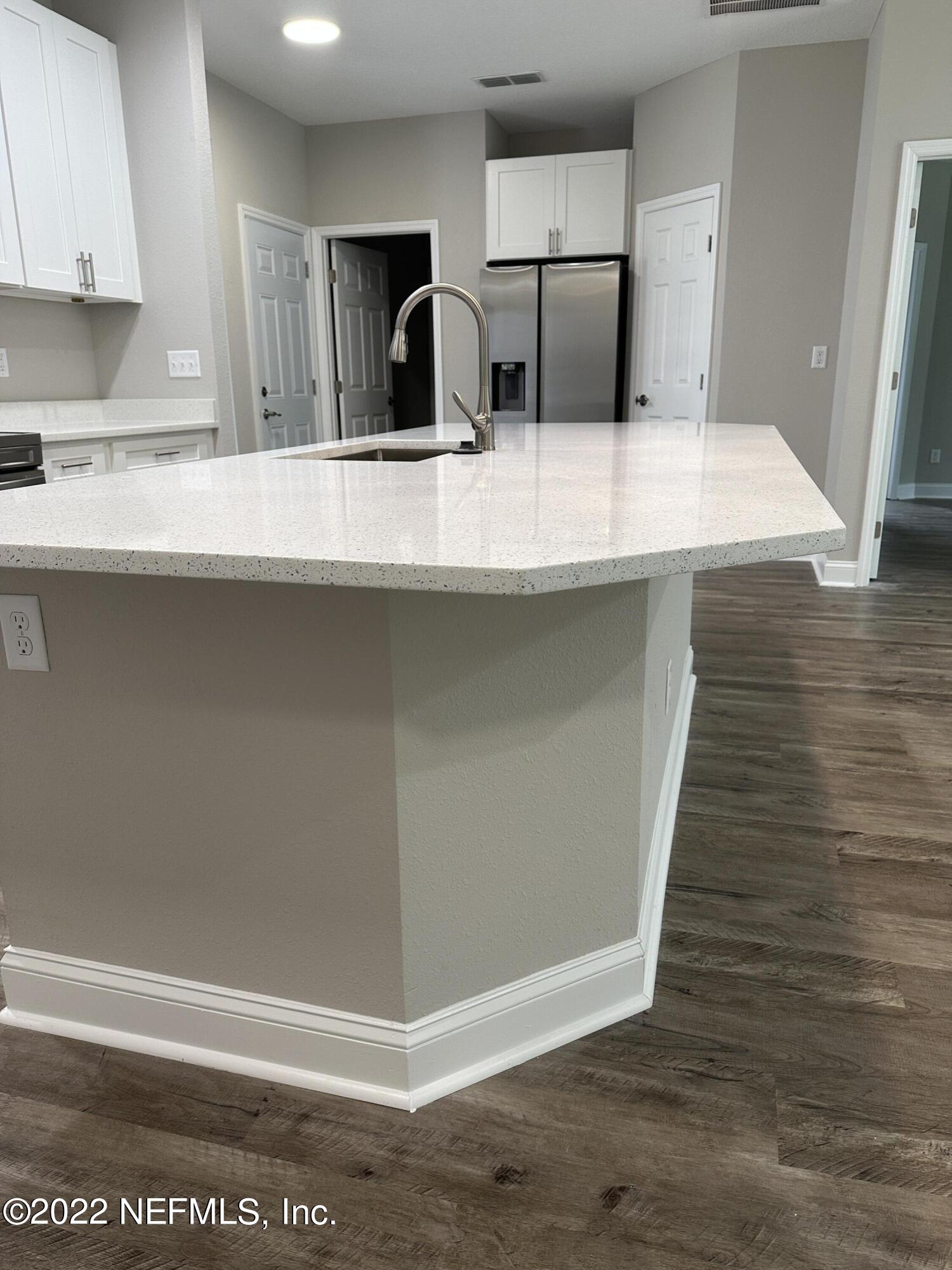 6458 Heidi Road Jacksonville, FL 32277 - Photo 7 of 26 a room with stainless steel appliances wooden floor and view kitchen
