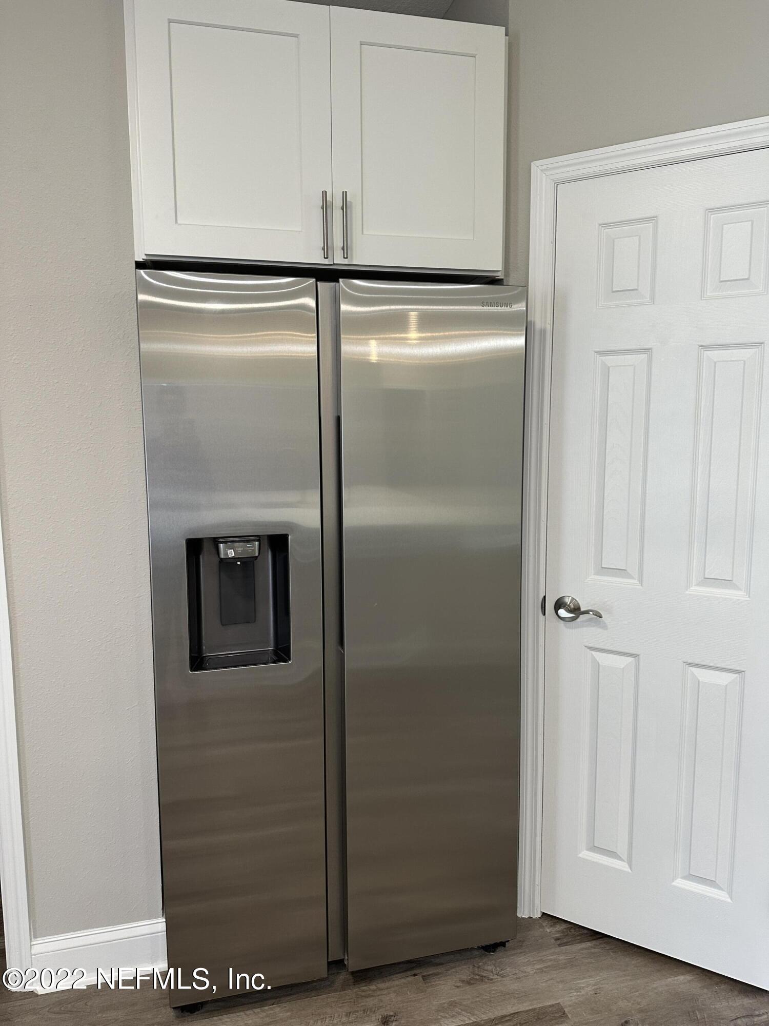 6458 Heidi Road Jacksonville, FL 32277 - Photo 9 of 26 a refrigerator freezer sitting inside of a room