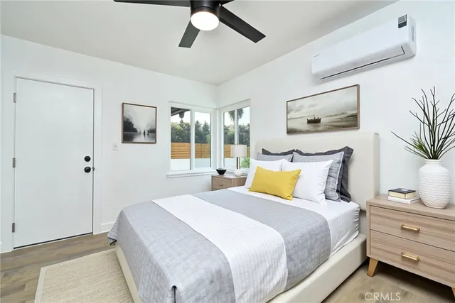 a bedroom with bed and wooden floor