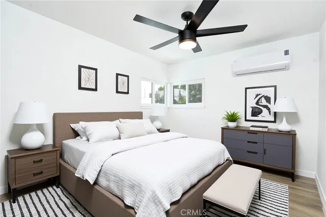 a bedroom with a bed and wooden floor