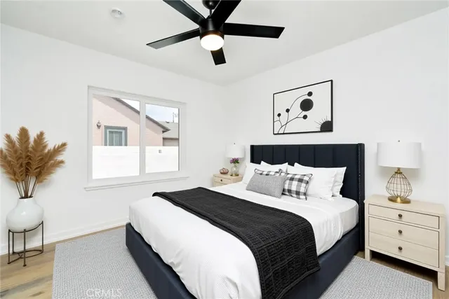 a bedroom with a large bed and a chandelier
