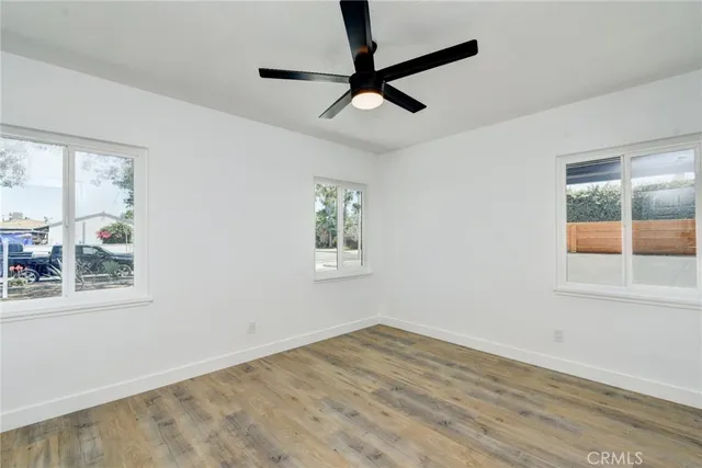 a view of room with a window and a ceiling fan