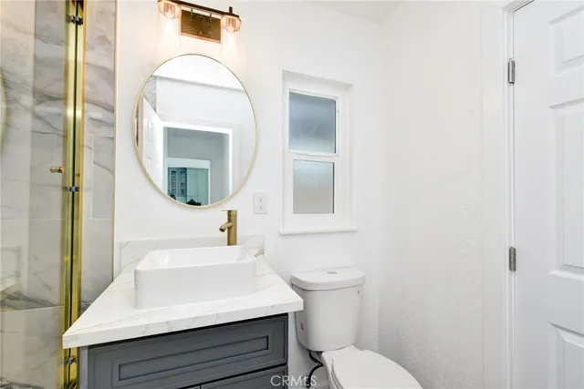 a bathroom with a sink toilet and mirror
