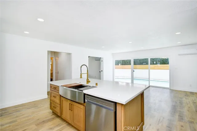 a kitchen that has a sink and a stove in it