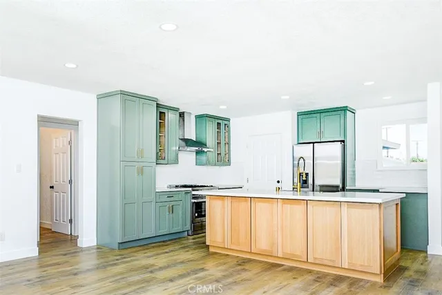 a view of kitchen with sink window and refrigerator