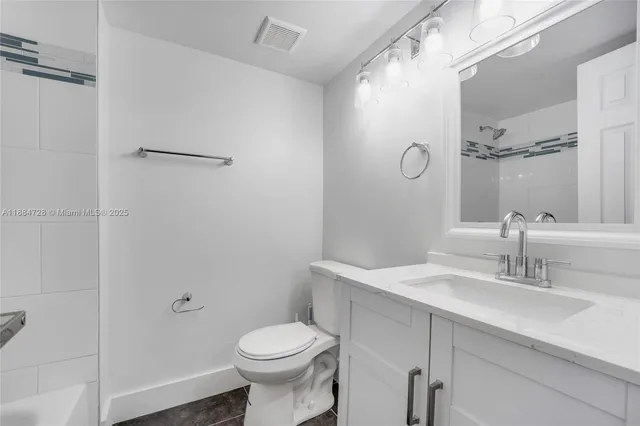 a bathroom with a sink toilet and vanity