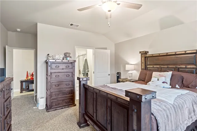a en suite bathroom with a granite countertop toilet and a shower