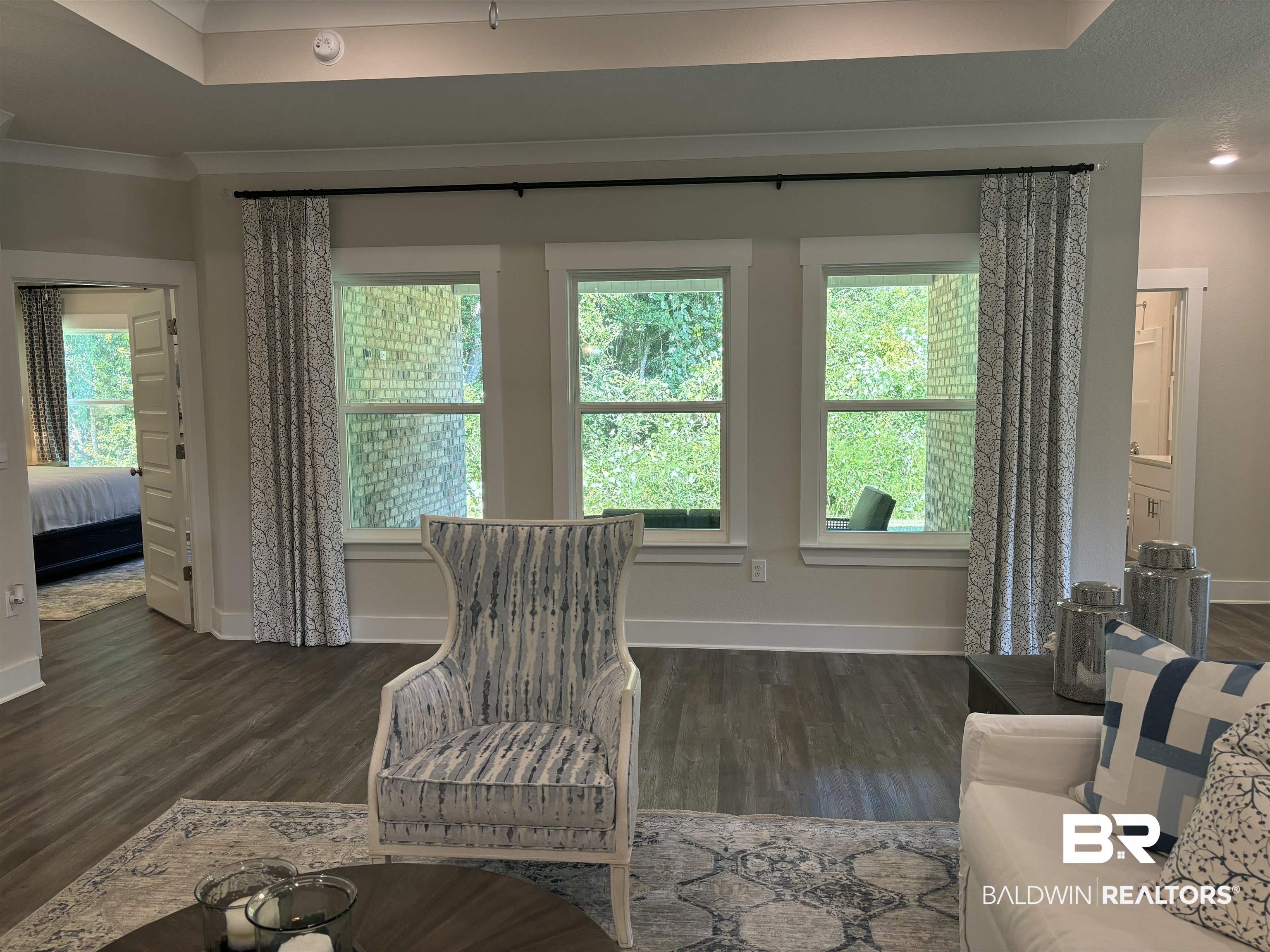 370 Barndling Street Fairhope, AL 36532 - Photo 8 of 30 Living room featuring crown molding, a healthy amount of sunlight, and dark hardwood / wood-style flooring