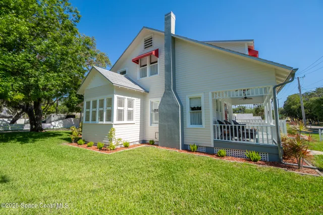 a living room with furniture a fireplace and a large window