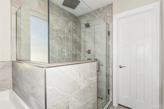 a bathroom with a glass shower door