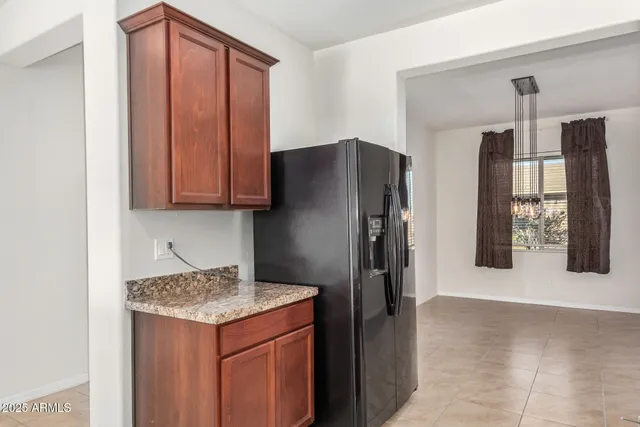 a kitchen with stainless steel appliances granite countertop a stove top oven a sink and a refrigerator