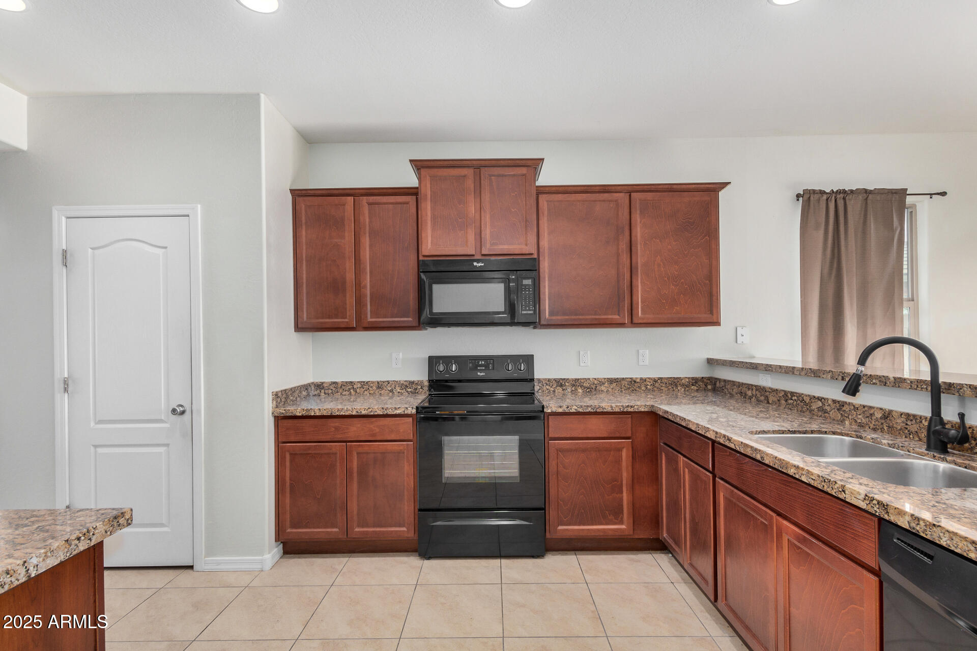 4880 South 246th Lane Buckeye, AZ 85326 - Photo 13 of 32 a kitchen with stainless steel appliances granite countertop a stove sink and cabinets