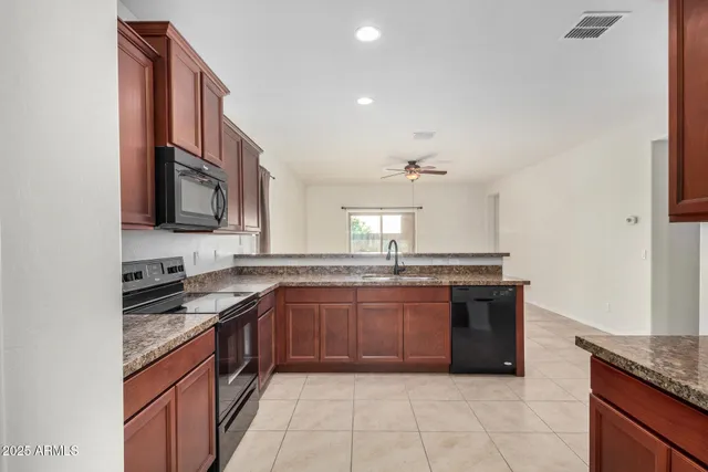 a kitchen with stainless steel appliances granite countertop a refrigerator and a sink