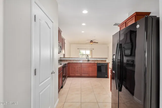 a kitchen with stainless steel appliances granite countertop a sink stove and cabinets