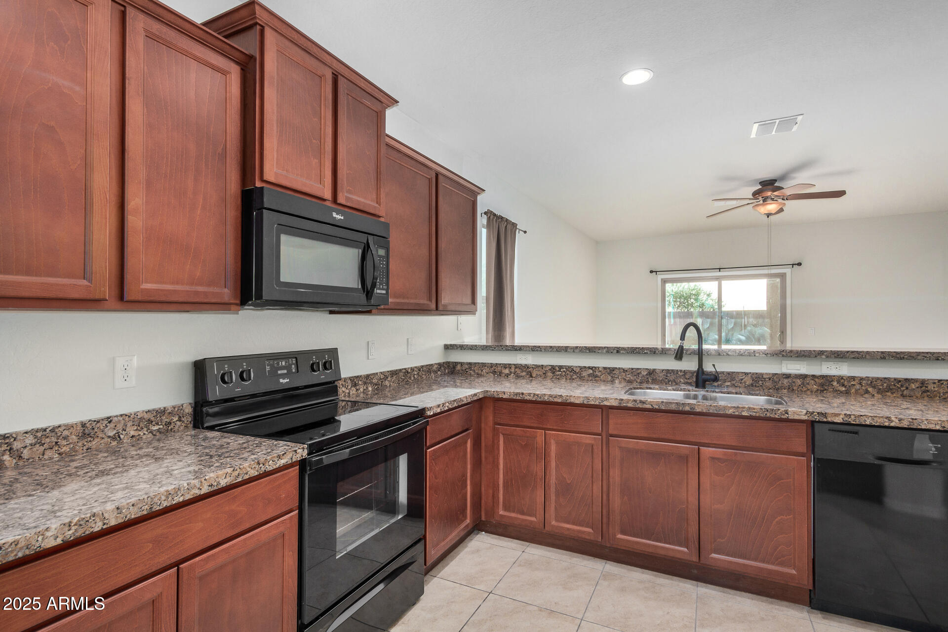 4880 South 246th Lane Buckeye, AZ 85326 - Photo 16 of 32 a kitchen with stainless steel appliances granite countertop a sink stove and cabinets