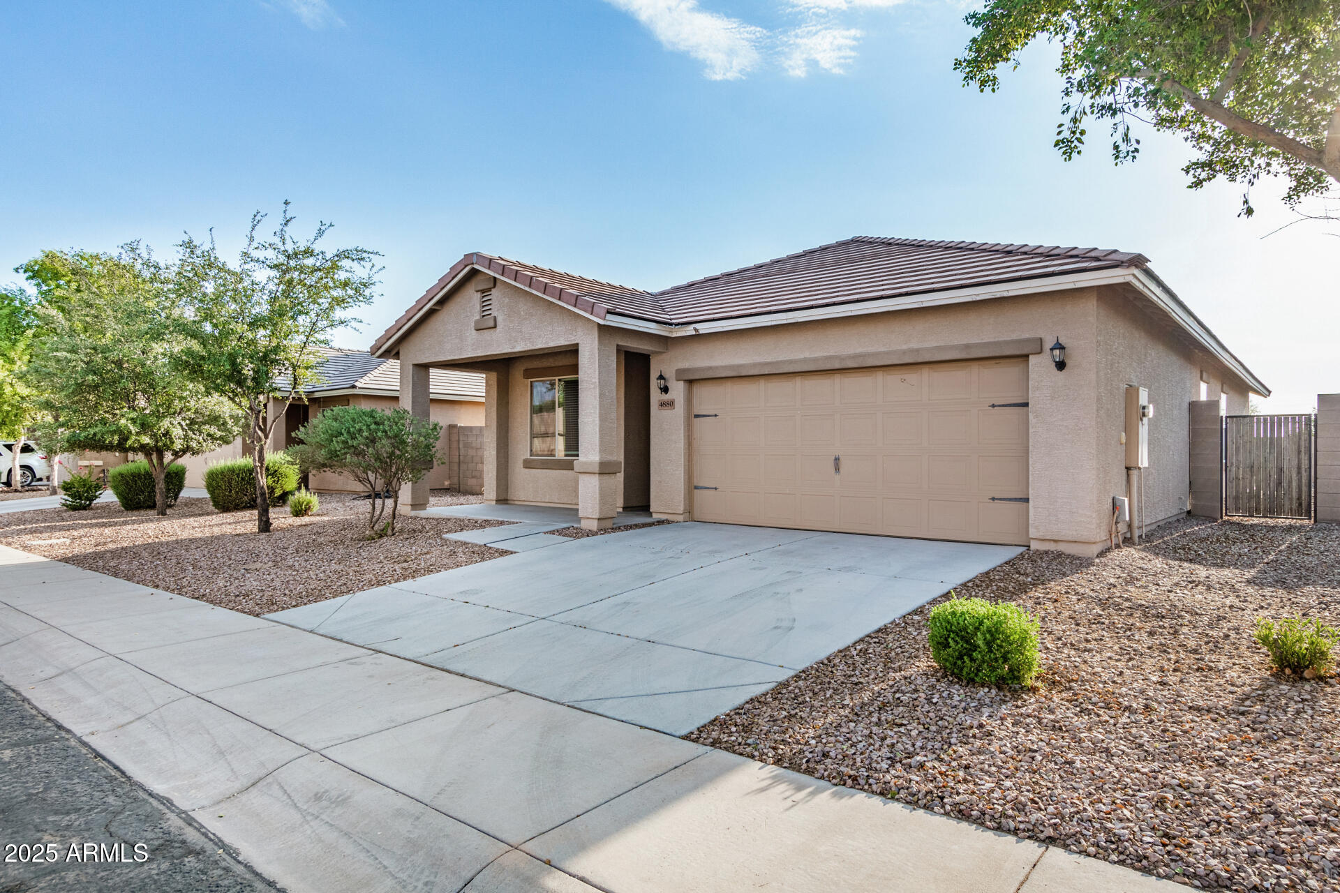 4880 South 246th Lane Buckeye, AZ 85326 - Photo 4 of 32 a front view of a house with a yard and garage