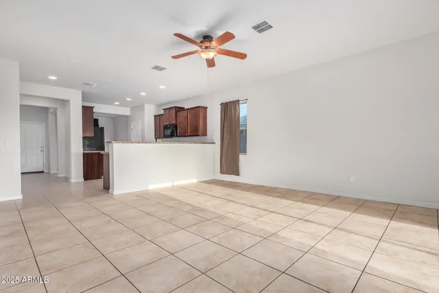 a view of kitchen with refrigerator and a stove top oven