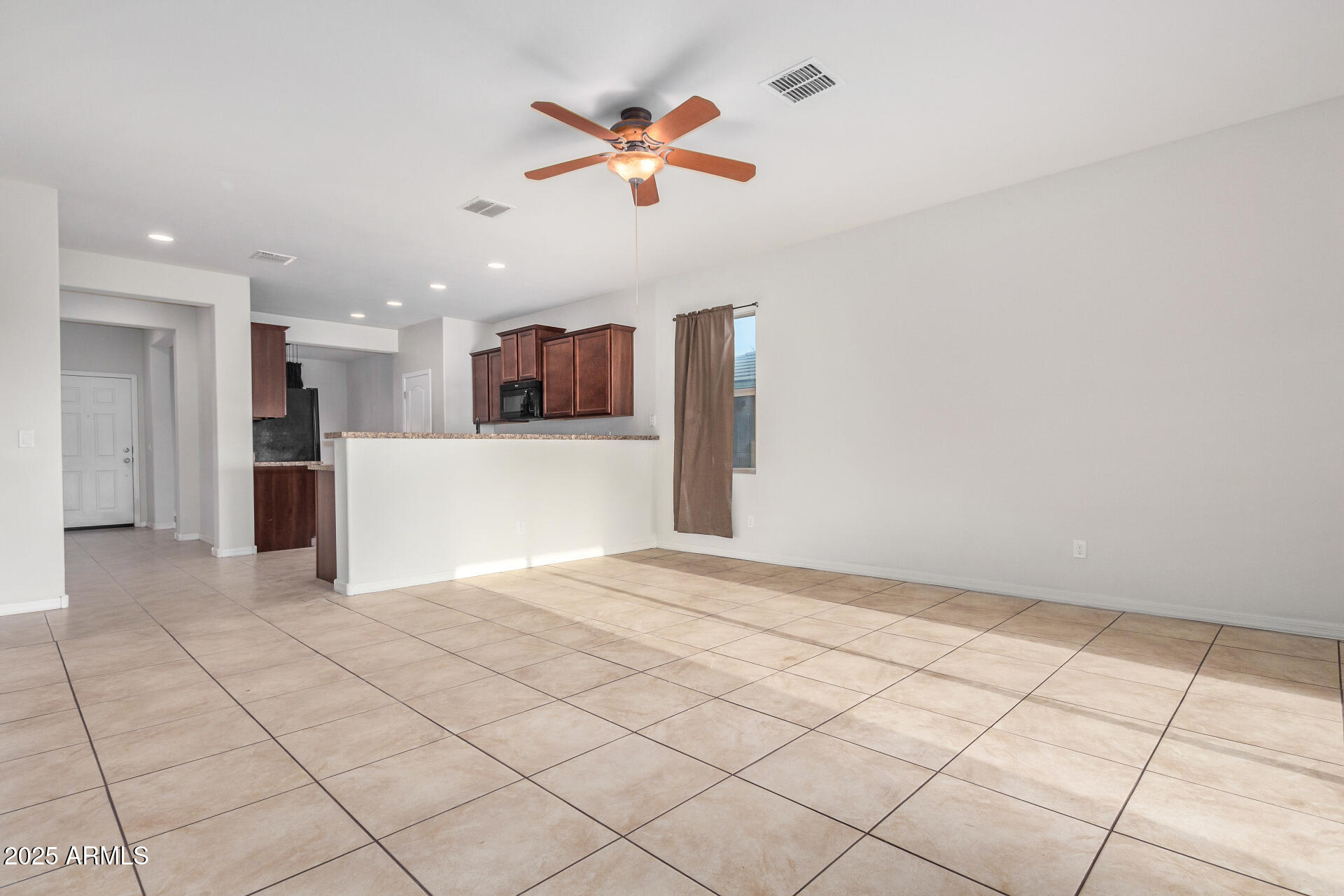 4880 South 246th Lane Buckeye, AZ 85326 - Photo 7 of 32 a view of kitchen with refrigerator and a stove top oven