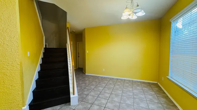 a kitchen with a refrigerator and a stove top oven